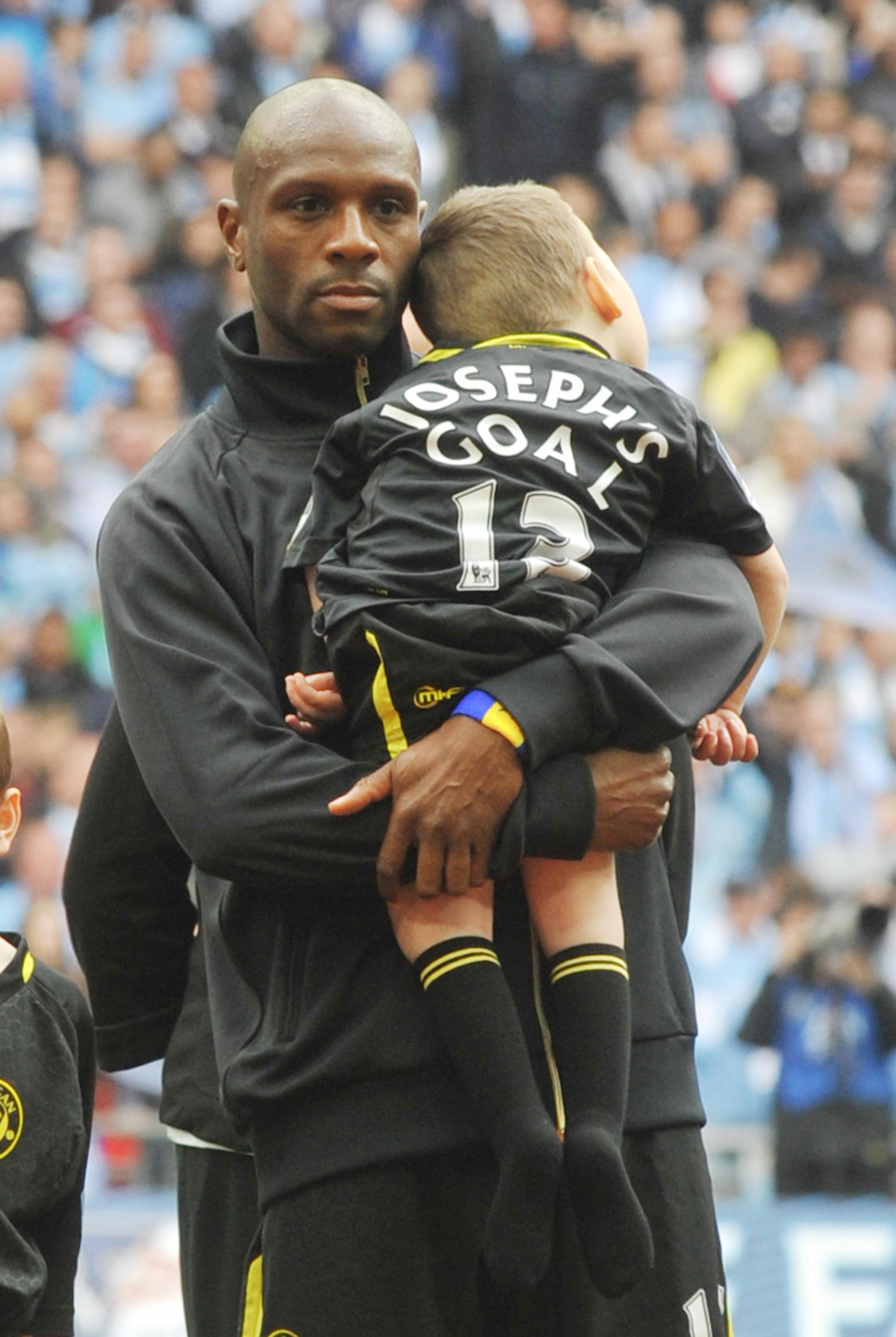 Handout photo issued by Josephs Goal of Joe Kendrick, a 10-year-old from Wigan with a rare life-limiting genetic disorder called nonketotic hyperglycinemia (NKH) with Wigan captain Emmerson Boyce at the 2013 FA Cup final, as amateur runner Chris Devine