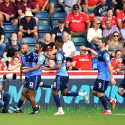 Wycombe Wanderers (pictured against Charlton Athletic in September 2021) are top of the League One table after a 3-0 win over Burton Albion (PA)