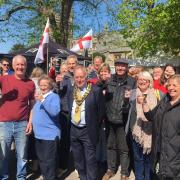 Traders raised a glass of bubbly with the Beaconsfield Mayor  Alastair Pike (front) and market manager Andrew Savage (left in red).