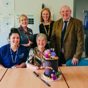 Kim Smith (centre) with Colin Graham, COO Sepsis Research FEAT (on Kim's left), Sarah Kent, Senior Sister MKUH ICU (on Kim's right), and members of the MKUH ICU team 2