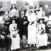 A family wedding, with Ellen sitting on the far right of the front row and her husband Mark Blackall on the far left, c.1915