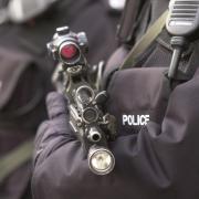 A stock image of an armed policeman