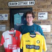 Bradley Strevens poses with two Wycombe shirts as part of his business