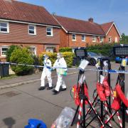 Forensic teams at the crime scene in Downley on May 10