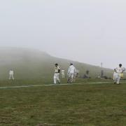 Two teams of 11 amateur players brought a 120kg artificial pitch, four bats and 30 balls to the summit of Helvellyn in the Lake District for the charity game.