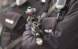 A stock image of an armed policeman