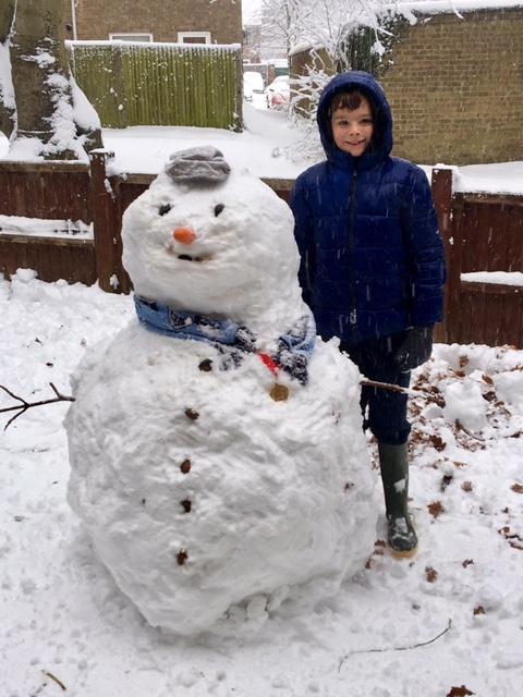 Nine-year-old Joshua Newton with his snowman Greg in Prestwood