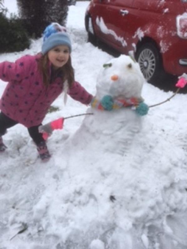 Little Amelie with her snowman