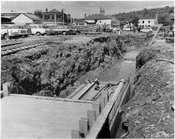The culverted River Wye prominent in a view looking NW from wasteland east of Newland Street towards Denmark Street, High Wycombe. June 1965